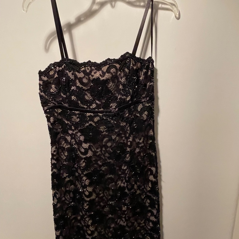 Black lace cocktail dress with beading and nude background size 4.